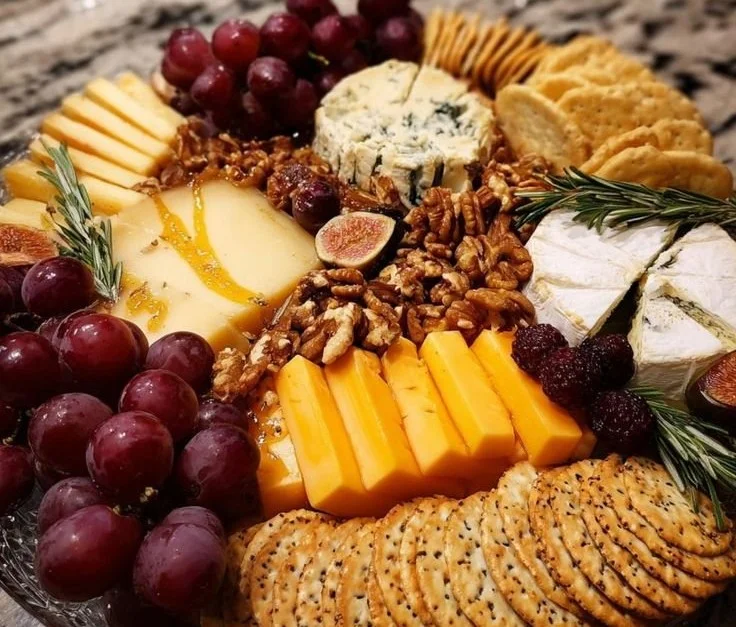 Delicious Christmas cheese platter with various cheeses, fruits, and nuts