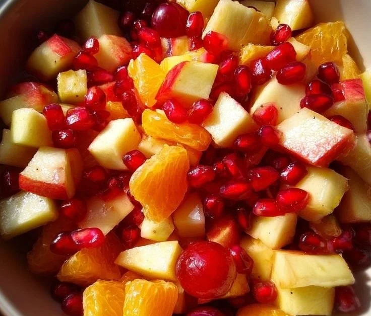 Colorful Christmas fruit salad featuring seasonal fruits in a festive bowl.