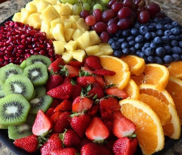 Colorful Christmas fruit tray with assorted seasonal fruits for holiday gatherings.