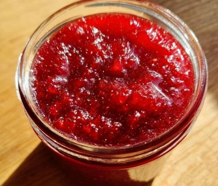 Homemade Christmas jelly jars decorated for the holiday season